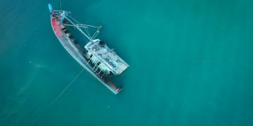 Aerial photograph of a sunken shipwreck in turquoise water near Chukai, Terengganu, Malaysia.