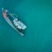 Aerial photograph of a sunken shipwreck in turquoise water near Chukai, Terengganu, Malaysia.