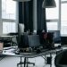 Contemporary workspace featuring computers, coding screens, and office essentials in a tech environment.