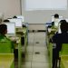 Children focus on computers in a modern classroom setting.