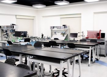 A contemporary classroom equipped with advanced technological tools and workstations.
