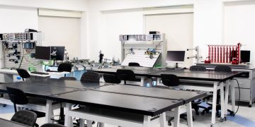 A contemporary classroom equipped with advanced technological tools and workstations.