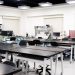 A contemporary classroom equipped with advanced technological tools and workstations.