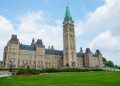 Stunning photo of Canada's Parliament Hill in Ottawa under a clear sky, showcasing Gothic Revival architecture.