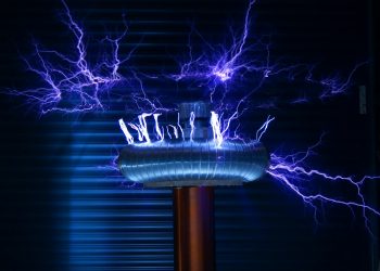A Tesla coil producing powerful electric arcs in a dark setting.