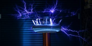 A Tesla coil producing powerful electric arcs in a dark setting.