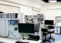 A contemporary computer lab with advanced workstations and electronic equipment, perfect for research and development.