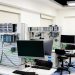 A contemporary computer lab with advanced workstations and electronic equipment, perfect for research and development.