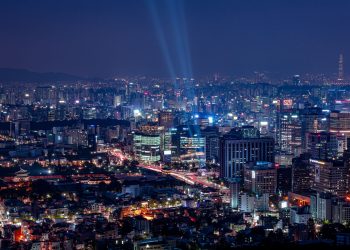 A breathtaking aerial view of a vibrant city illuminated at night.