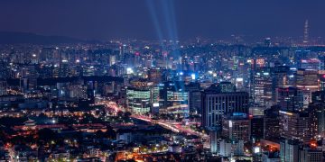 A breathtaking aerial view of a vibrant city illuminated at night.