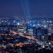 A breathtaking aerial view of a vibrant city illuminated at night.