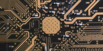 Detailed image of a printed circuit board highlighting electronic pathways and components.