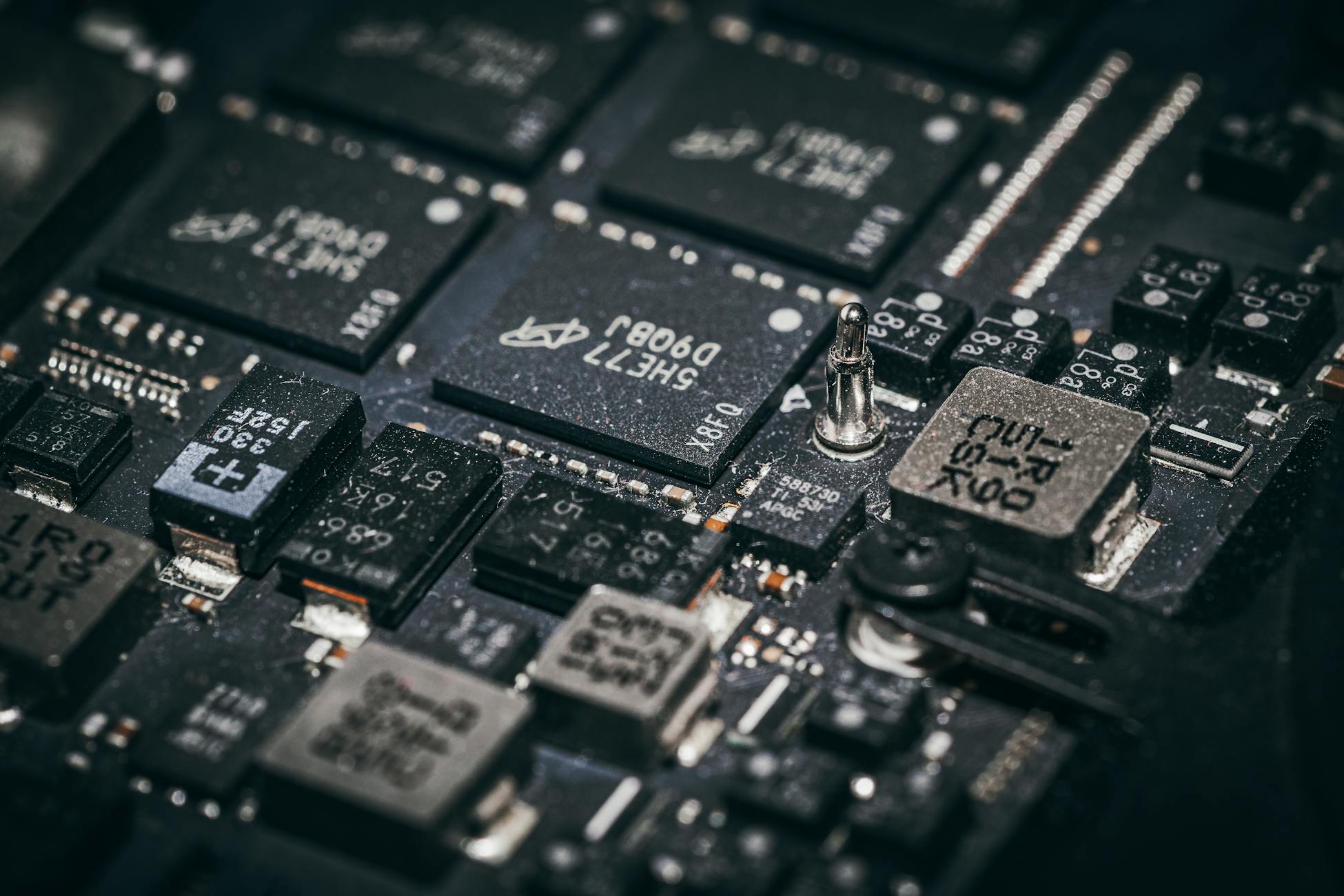 Detailed close-up of electronic microchips on a circuit board, showcasing technology and engineering intricacies.