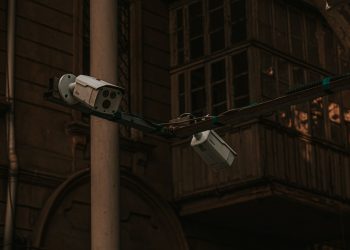 Street security cameras mounted on a pole in an urban environment, highlighting surveillance.