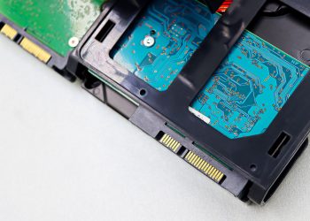 Detailed view of computer hard disk drive components, showcasing circuitry and connectors.