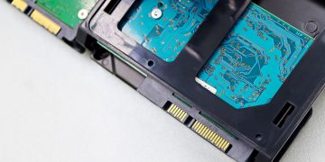 Detailed view of computer hard disk drive components, showcasing circuitry and connectors.