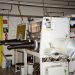An industrial laboratory setup featuring a glove box with safety equipment.