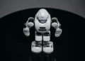A detailed view of a white robot toy standing on a black surface, showcasing modern toy technology.