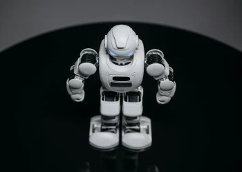 A detailed view of a white robot toy standing on a black surface, showcasing modern toy technology.