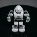 A detailed view of a white robot toy standing on a black surface, showcasing modern toy technology.