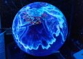 A vibrant illuminated globe display showcasing technological advancements at a science museum.