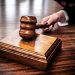 Close-up of a wooden gavel on a judge's desk, symbolizing justice.