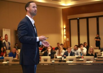 A dynamic speaker engages professionals during a business conference presentation.
