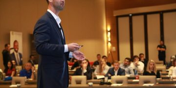 A dynamic speaker engages professionals during a business conference presentation.