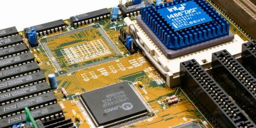 Detailed view of an Intel i486 DX2 CPU installed on a vintage motherboard with chips and circuits.