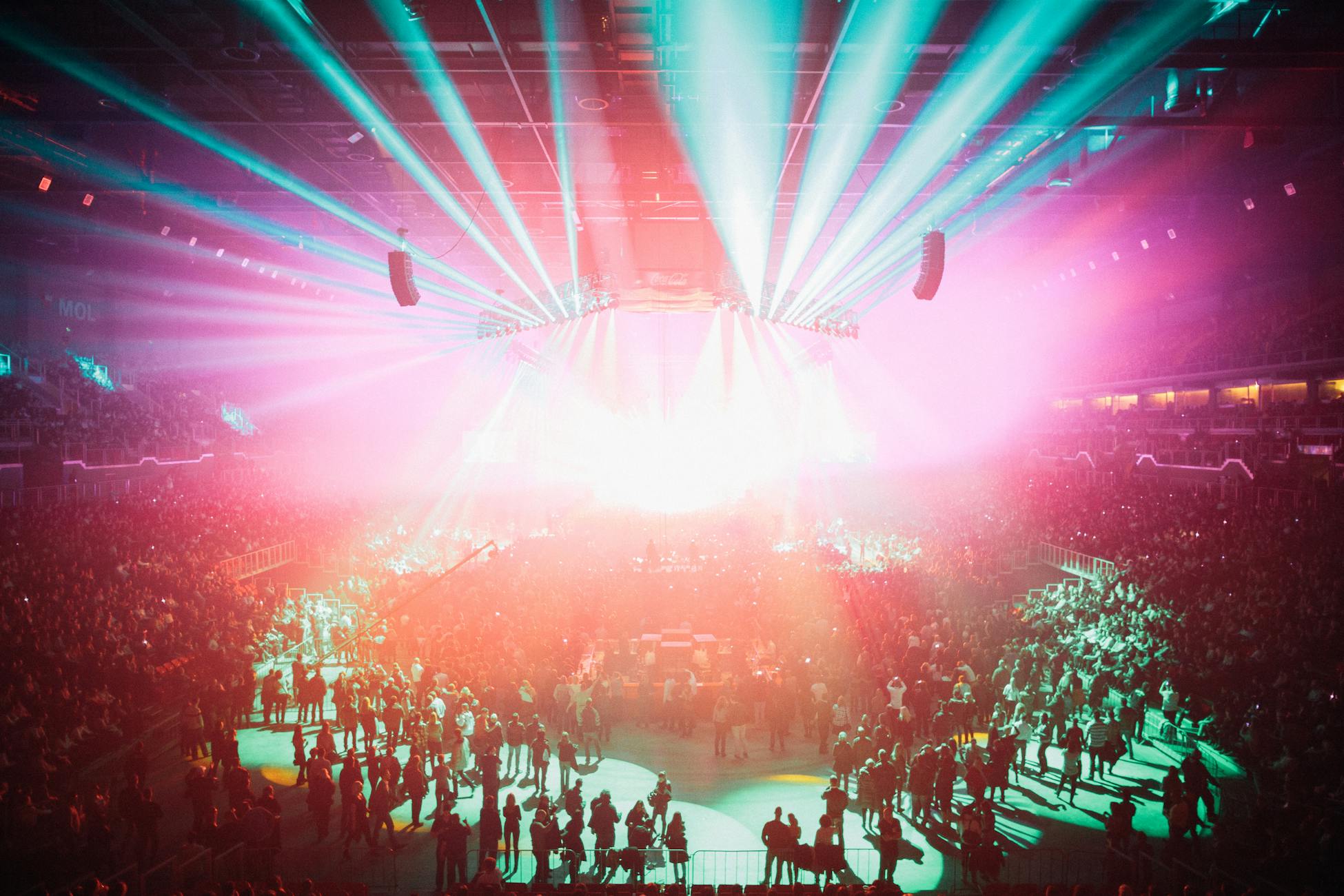 An electrifying concert scene with colorful lights and a large audience in Budapest Arena.