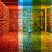 A vibrant, rainbow-themed room featuring patterned walls and colored glass panels creating a kaleidoscopic effect.