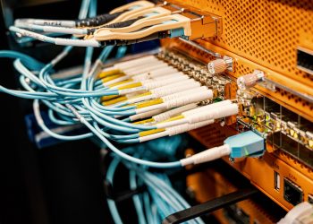 Modern hardware and structured cabling system with patch cords inserted into patch panel outlets