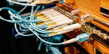 Modern hardware and structured cabling system with patch cords inserted into patch panel outlets