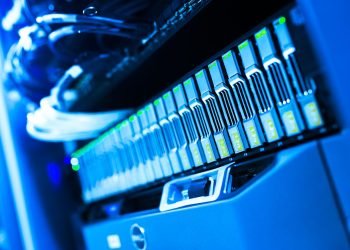 A detailed view of a blue lit computer server rack in a data center showcasing technology and hardware.
