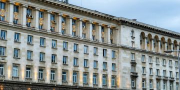 Illuminated government building in Sofia, showing classic architectural design under a twilight sky.