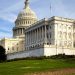 A picturesque view of the US Capitol Building in Washington, DC, under a clear sky.