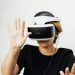 Woman experiencing virtual reality with VR headset on white background.