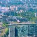 Aerial cityscape featuring the Microsoft Building and Seine River in Paris, showcasing urban architecture and lush greenery.