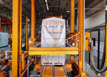 An industrial machine in a glass factory showcasing automated packaging in Dar es Salaam.