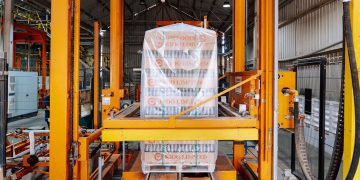 An industrial machine in a glass factory showcasing automated packaging in Dar es Salaam.