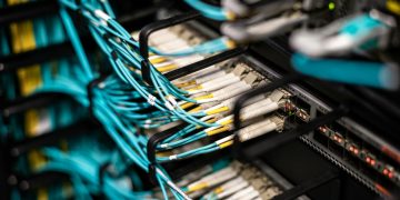 Numerous wires and cables mounted into server patch panel in modern data center