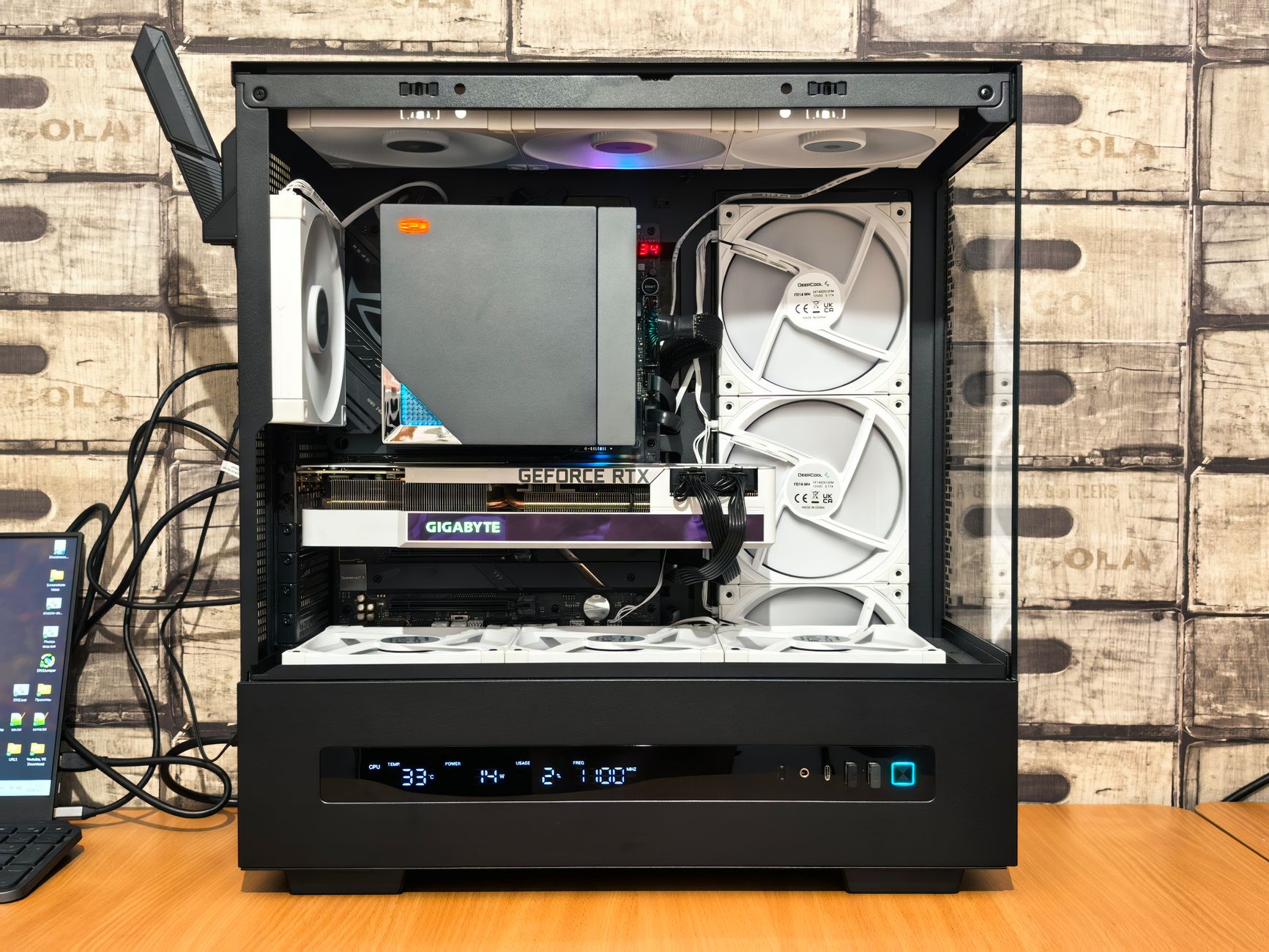 High-end gaming PC with open case showcasing internal components and cooling fans.