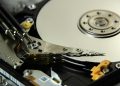Detailed view of internal hard drive platters and read/write heads for data storage technology.