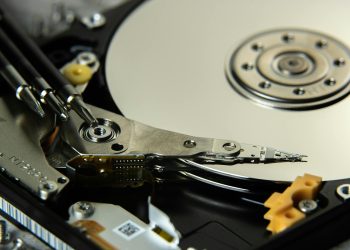 Detailed view of internal hard drive platters and read/write heads for data storage technology.