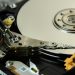 Detailed view of internal hard drive platters and read/write heads for data storage technology.