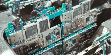 Close-up of intricate circuit boards in a Vietnamese factory, capturing modern electronics production.