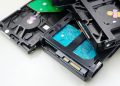 Stack of internal hard disk drives for digital storage on white background.