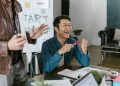 Engaged team members in a lively office meeting discussing startup ideas and innovation.