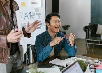 Engaged team members in a lively office meeting discussing startup ideas and innovation.