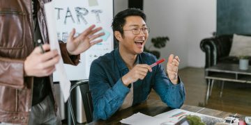 Engaged team members in a lively office meeting discussing startup ideas and innovation.